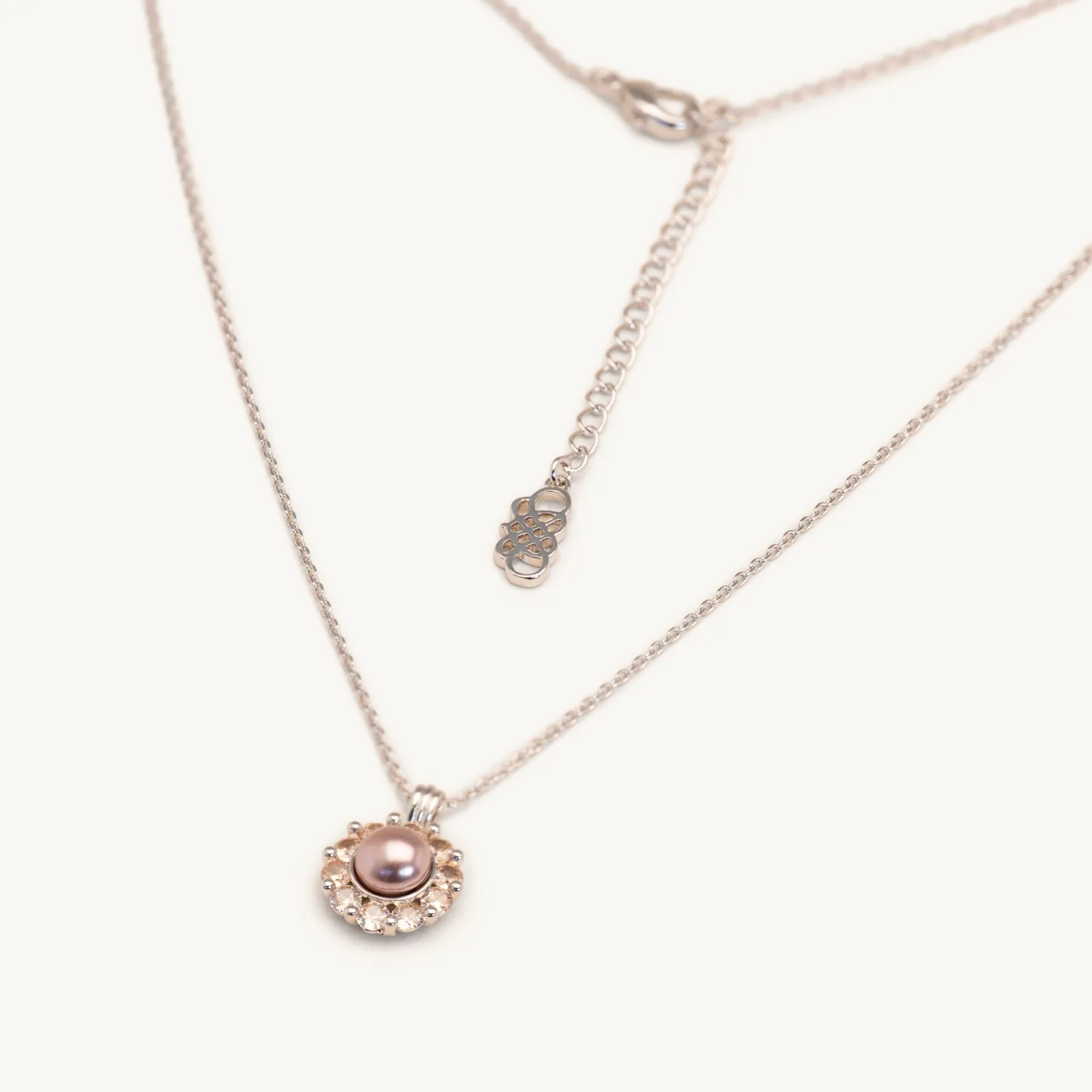 Pink pearl pendant framed by champagne crystals on a fine chain