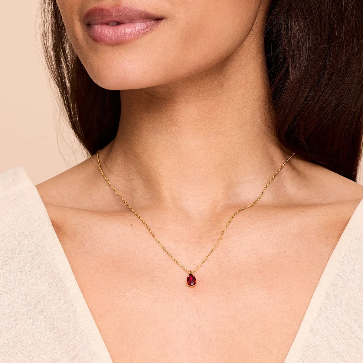 Gold necklace with a single birthstone crystal